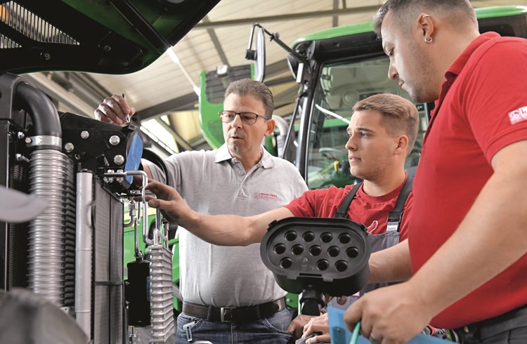 Arbeit am Traktor: (von links) Unternehmer Urs Kurmann, Lehrling Silvano Buob und Produktionsleiter Jost Amrhyn. Foto Schweizer Paraplegiker-Stiftung